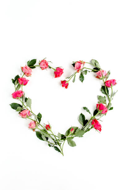 istock The heart is lined with red roses on white background. Valentine's background. Floral pattern. Flat lay, top view 1272878027