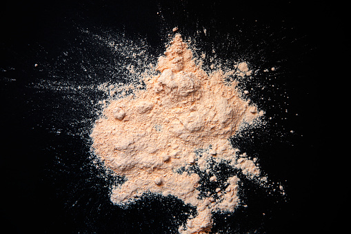 Nude powder texture on black background
