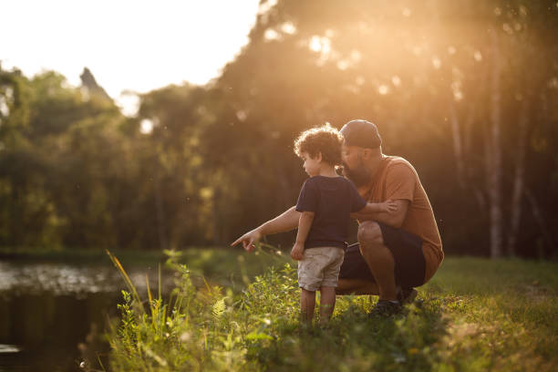 istock Father showing lake to his son 1272879937