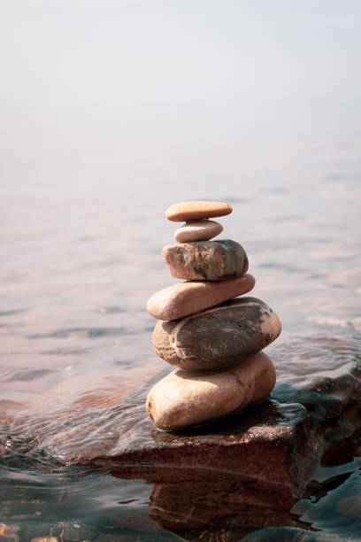 Man in tree pose yoga on rock
