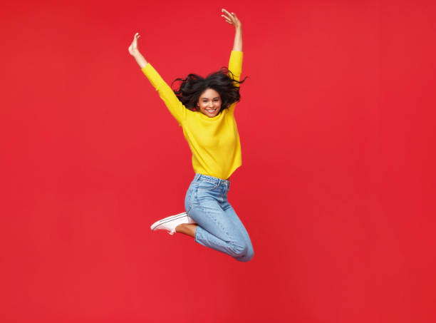 istock Happy ethnic woman smiling and jumping 1272880099