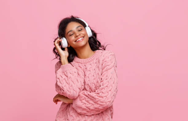 istock Delighted ethnic woman enjoying music 1272880741
