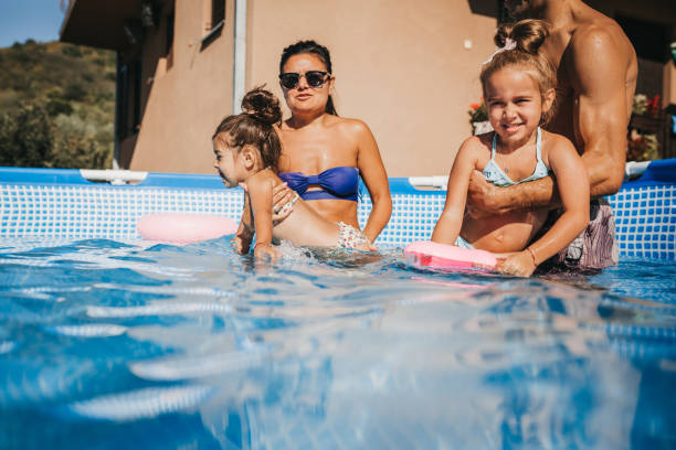 istock Beautiful Family Having Fun in the pool 1272884353