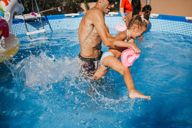 istock Beautiful Family Having Fun in the pool 1272884556