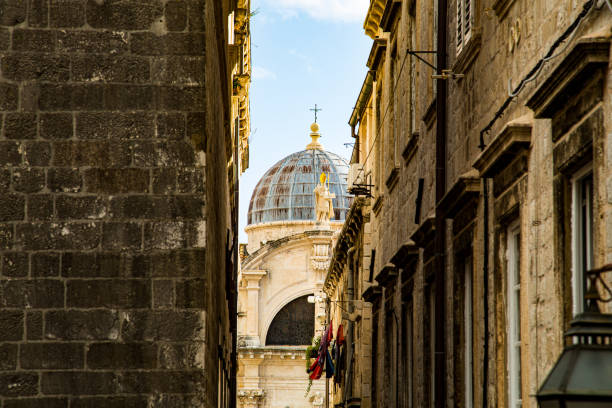 istock Oval dome of church between alleys 1272885648
