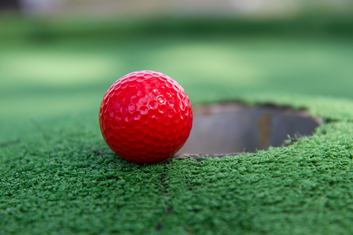 A golf ball at the hole