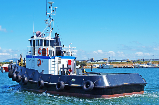 An 18 Meter twin screw Commercial Tug Boat under way in Gladstone Marina Harbour. Gladstone, Queensland, Australia.