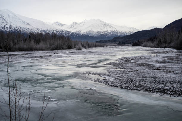 istock Winter scene in Alaska with  broad river with flowing water 1272889603