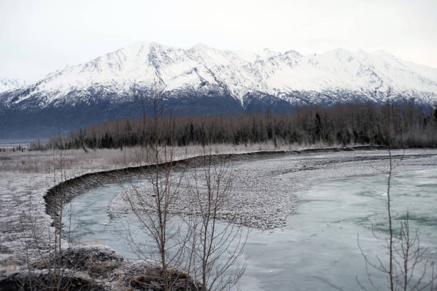 istock Winter scene in Alaska with  broad river with flowing water 1272889643