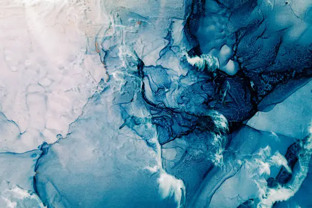 Photo of blue acrylic ink marble texture frozen water white