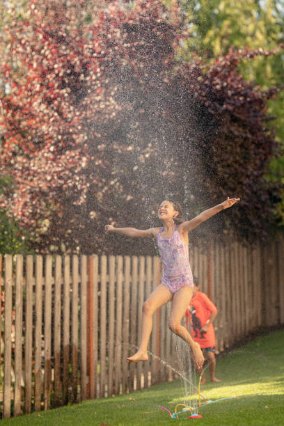 istock Siblings playing in backyard on a hot summer day 1272890012