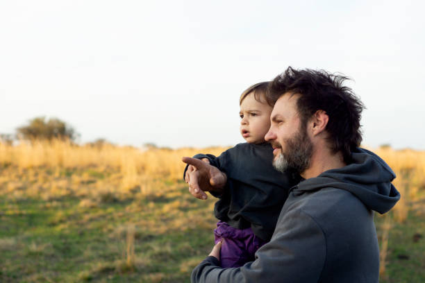 istock father in the field with his son 1272890029