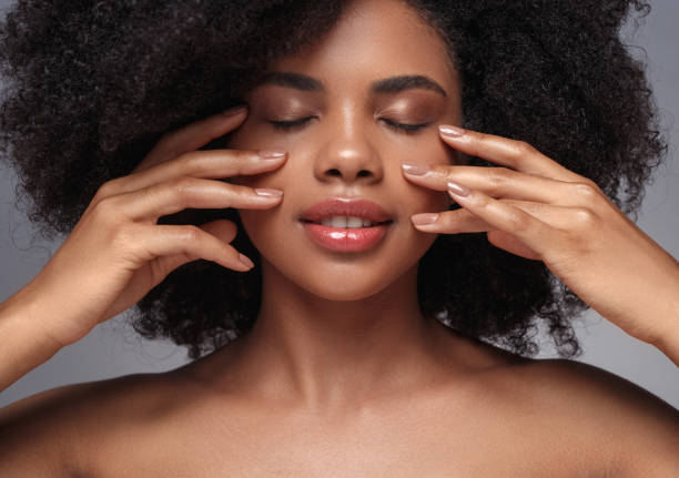 istock Beautiful black model touching perfect clean skin 1272890418