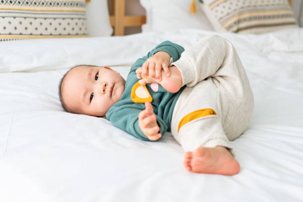 istock Asian infants crawling and playing on bed 1272892326