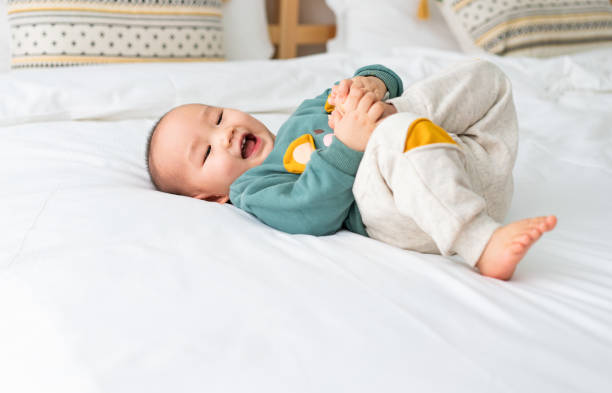 istock Asian infants crawling and playing on bed 1272892330