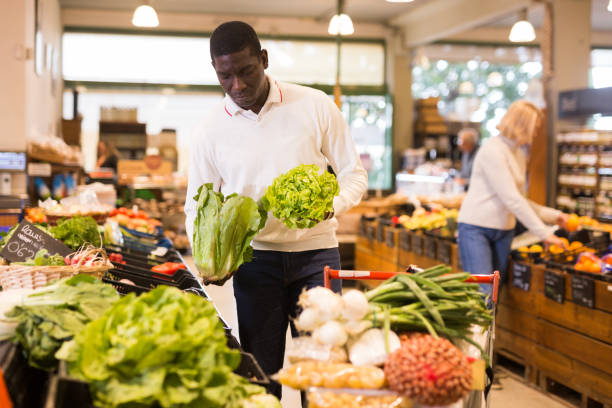 istock Man choosing vegetables in store 1272897866