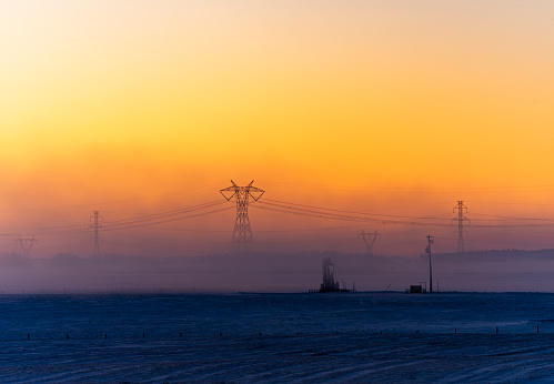 Electricity industry - high voltage towers in sunrise.
