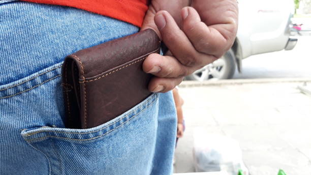 istock man picking wallet from jeans pocket 1272901597