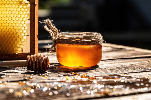 istock Natural honey with a spoon on old rustic table. bee products by organic natural ingredients concept, closeup 1272903772