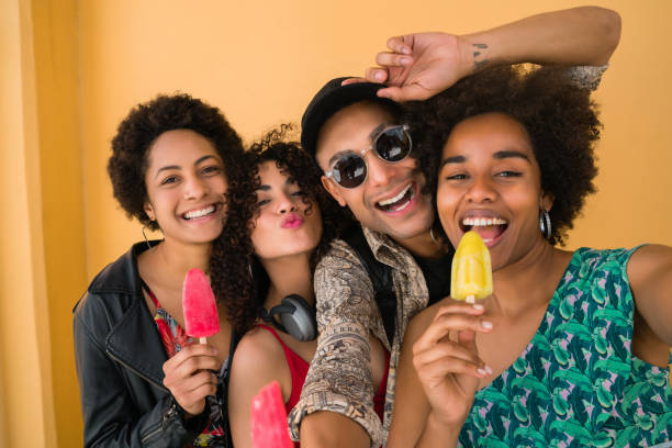 istock Multi-ethnic group of friends enjoying summertime while eating ice cream. 1272909545
