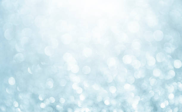 istock White glitter vintage lights background. Bokeh silver and white. defocused and copy space. 1272911597