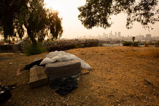 Sunset view of a bedding area of a homeless encampment.