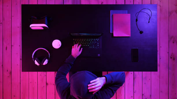 istock Man in glasses playing a game on laptop 1272915164