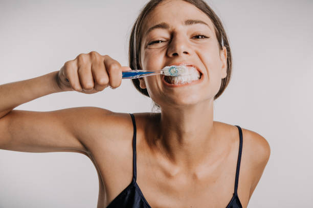 brushing teeth looks fun - brushing teeth women toothbrush brushing imagens e fotografias de stock