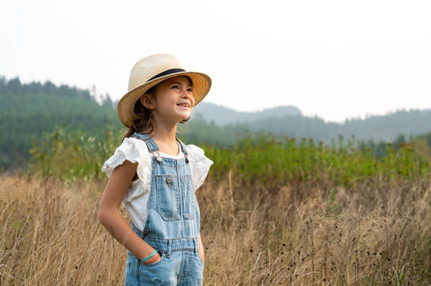 Young girl looking to the future on a farm. confident young girl looking to the distance. Girl outside in nature.