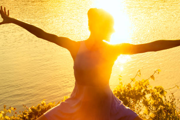 istock Woman dancing with intense reflections of the setting sun. 1272916158