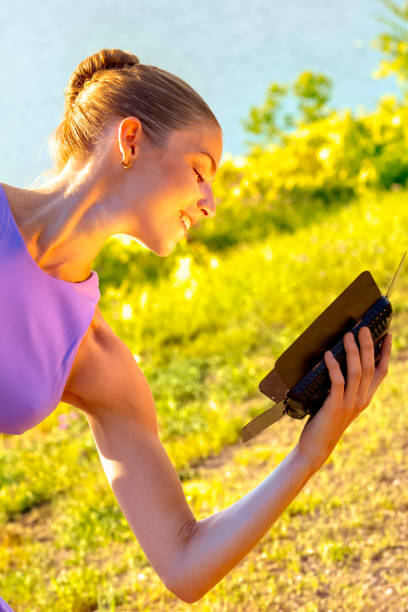 istock Woman dancing at sunset while holding a light box. 1272916308