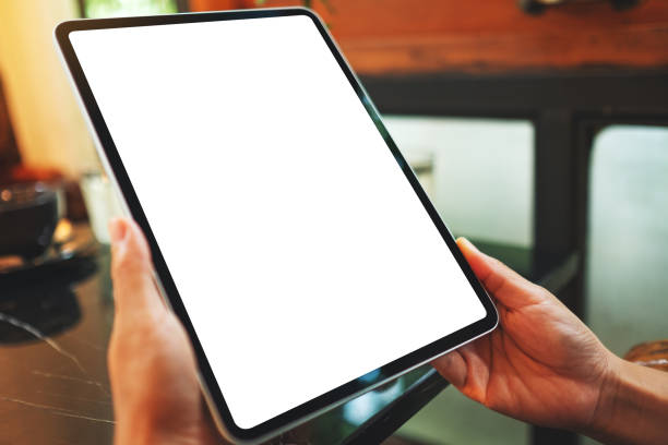 istock a woman holding digital tablet with blank white desktop screen 1272917261