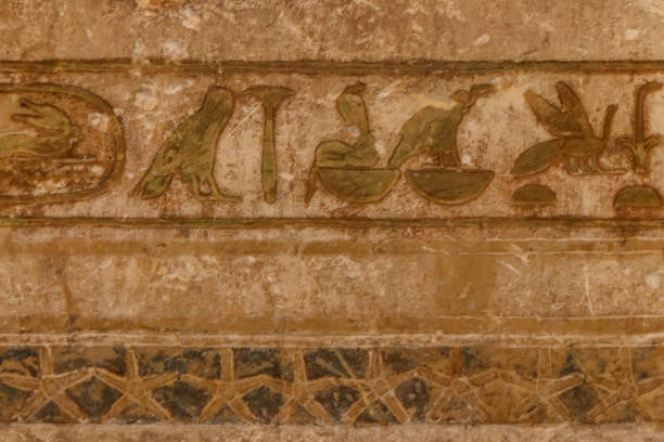 istock Ancient egyptian hieroglyphs carved on the stone wall 1272917974
