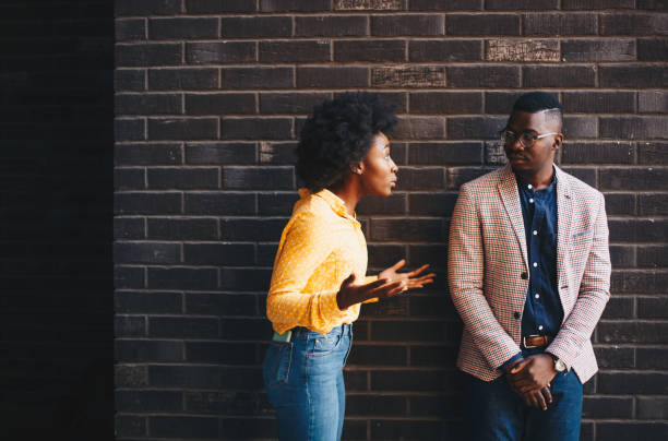 istock A young beautiful curly woman stands with her man, she explains something to him while he seems thoughtful 1272919804