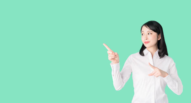 istock Young asian girl pointing at blank space. 1272920219