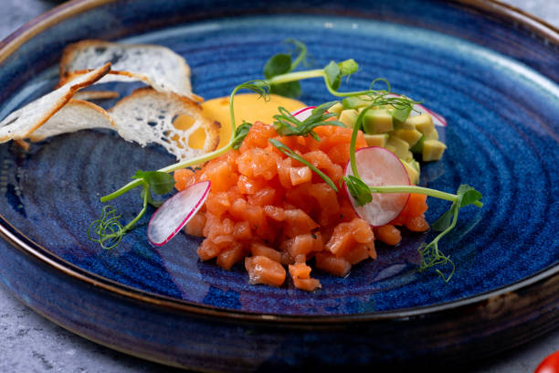 istock Salmon appetizer and chopped avocado in a plate 1272922281