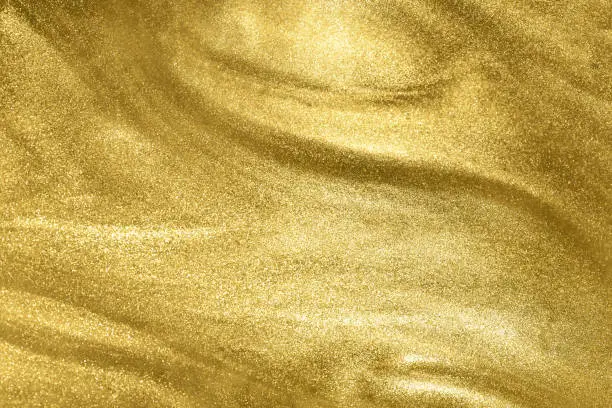 Photo of gold glitter shimmering magic bokeh background