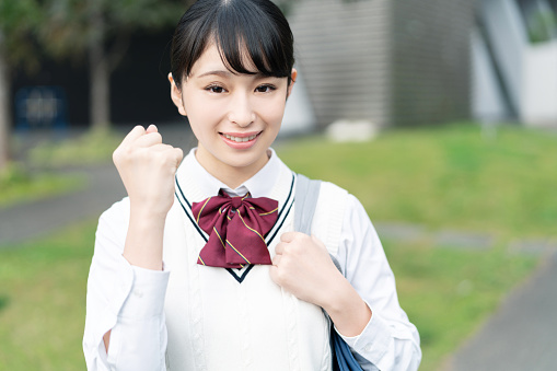 Cheerful asian school girl.