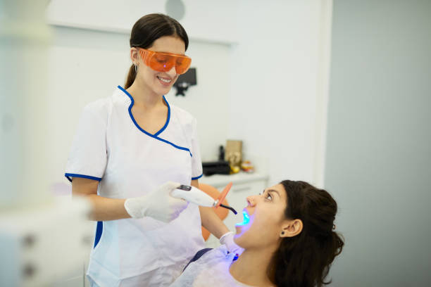 istock A female dentist using a cordless dental LED curing light lamp 1272924819