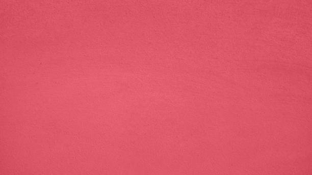 istock Modern Bright crimson low contrast concrete textured wall background, great design for any purposes. Wall fragment with scratches and cracks 2021 color trend 1272924960
