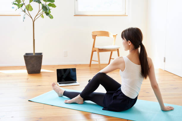 istock Young woman exercising in the room 1272928093