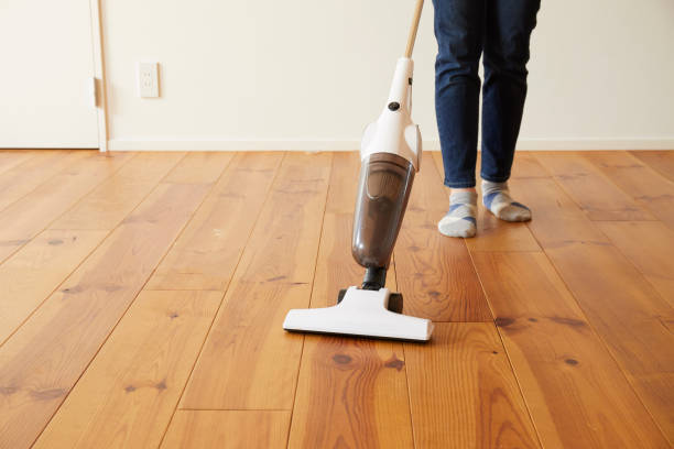 istock Young woman cleaning with a vacuum cleaner 1272928241