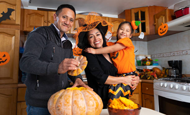istock Family carving a pumpkin in Halloween 1272928601