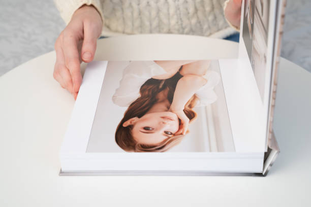 istock flipping through wedding photo book 1272928613