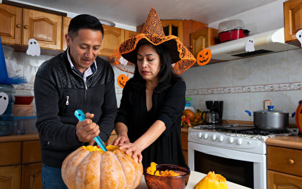 istock A couple carving a pumpkin in Halloween 1272928625
