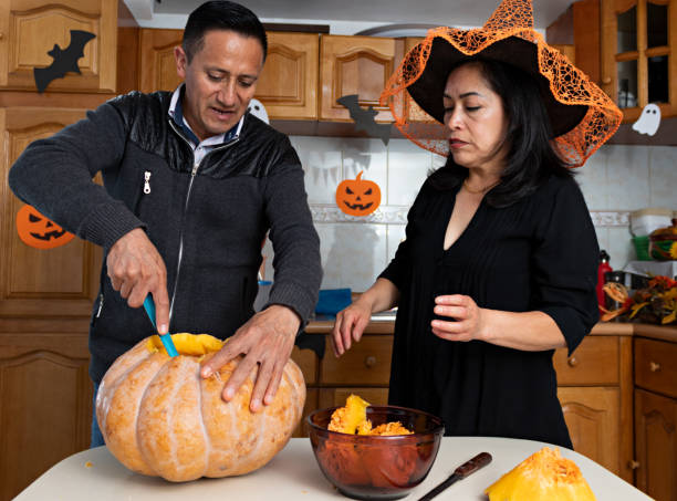 istock A couple carving a pumpkin in Halloween 1272928648