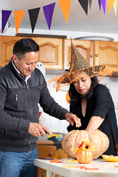 istock A couple carving a pumpkin in Halloween 1272931012