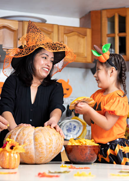 istock A woman with a kid carving a pumpkin 1272931048