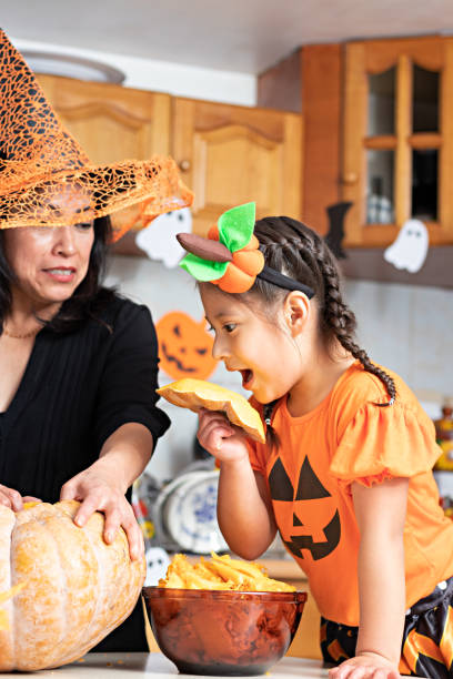 istock A woman with a kid carving a pumpkin 1272931067