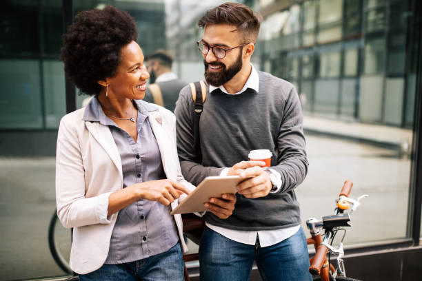 istock Business people on coffee break using digital tablet outdoor 1272931124